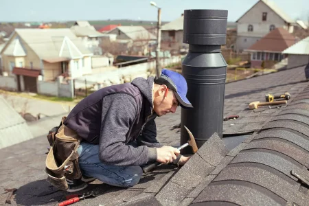 a-professional-master-roofer-with-hammer-repairs-